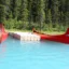 two red canoes sitting at the dock on the water