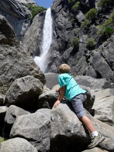 Little boy climbing near Mist Falls in Yosemite National Park