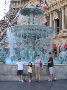 Family posing in front of a fountain in Las Vegas