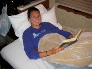 Teenage girl reading in the bed of her RV
