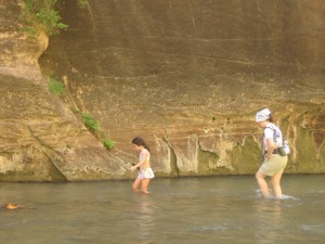 Mother and daughter walking in Zion Narrows with water to their knees