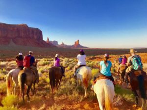 people on horses looking at national park