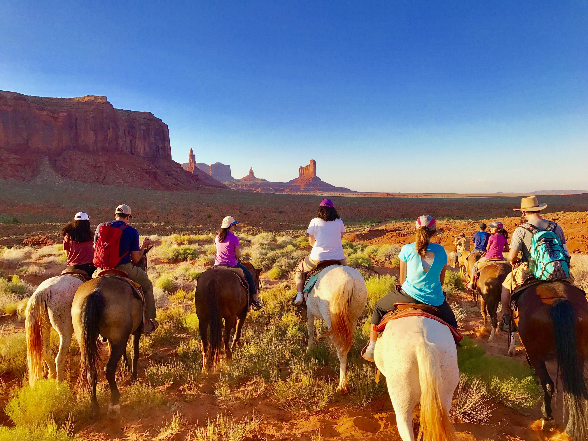 people on horses looking at national park