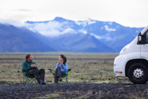 couple camping out in front of mountains