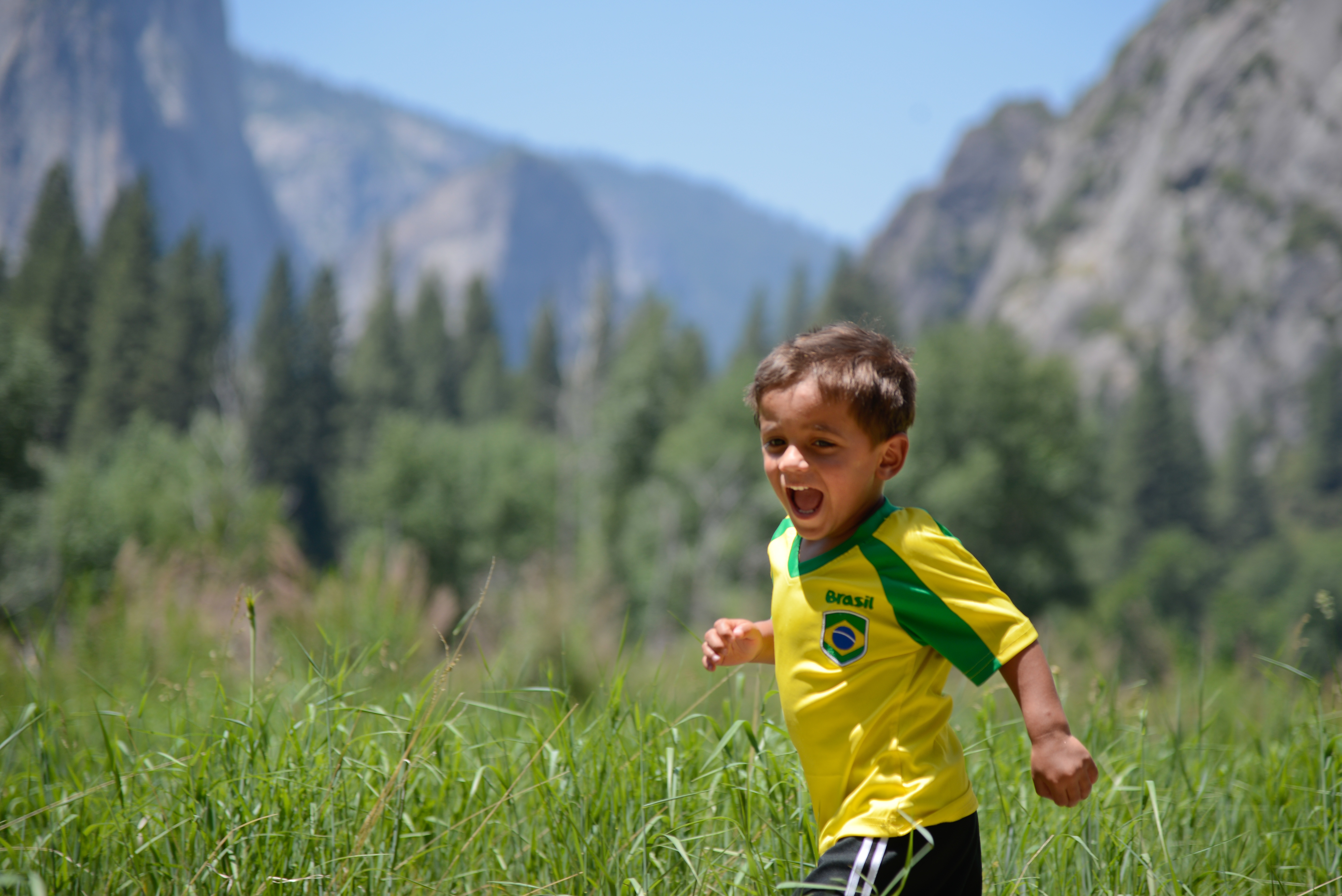 Boy running in Yorsemite Valley, ways to give back to national parks blog