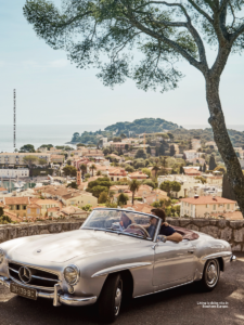 couple in classic convertible overlooking southern europe